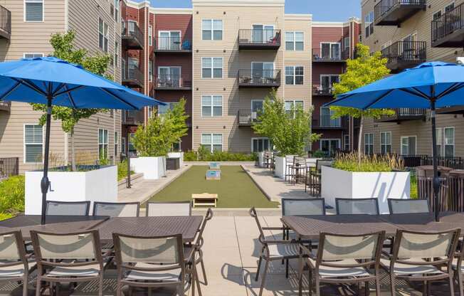 our apartments have a large patio with tables and chairs and umbrellas