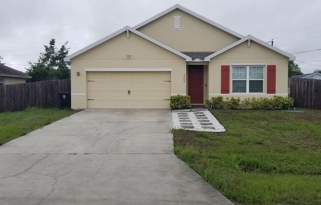 Newer, Spacious 4 bedroom, 2 bath, 2 car garage, tiled throughout and with fenced backyard