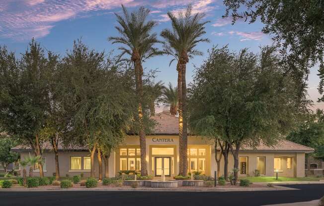 the facade of a building with palm trees in front of it