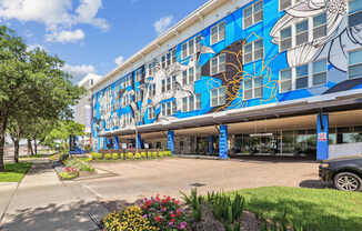 A building with a blue and white mural of fish on the side.