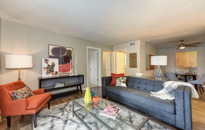  Living Room and Dining Area with Wood Inspired Floors,  Orange Chair, Hardwood Inspired Floor, Gray Sofa, Black/White Rug 