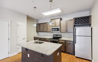 a kitchen with an island and stainless steel appliances