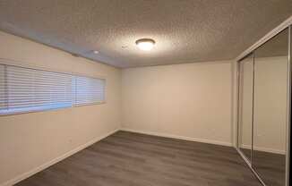 Bedroom with Hard Floors and Mirrored Wardrobe Closet