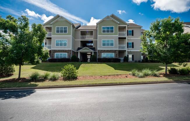 Residential building with beautiful landscaping at Riverstone apartments for rent in Macon, GA