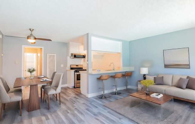 A modern living room with a dining table and chairs.