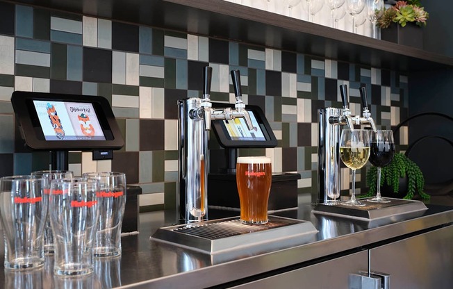 a bar with pitchers of beer and glasses on it