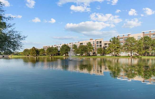A serene lake with a building in the background.