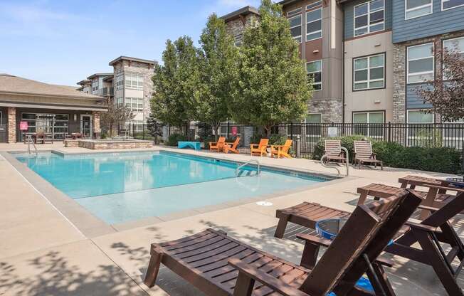 our apartments have a swimming pool with chairs and tables