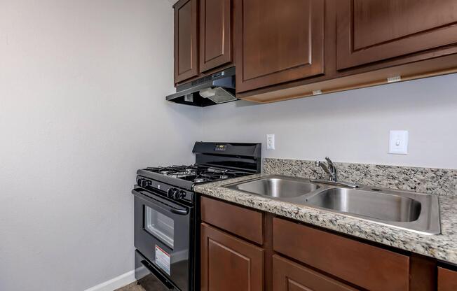 a kitchen with a stove a sink and a microwave