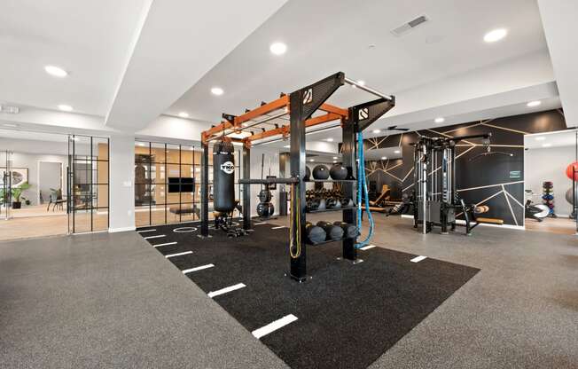 a gym with weights and other exercise equipment in a building with glass doors