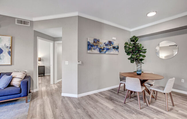 a dining room with a table and chairs