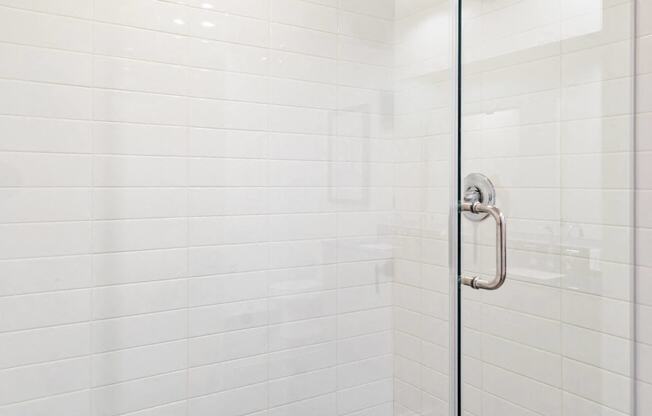 a bathroom with a shower and a stool in it