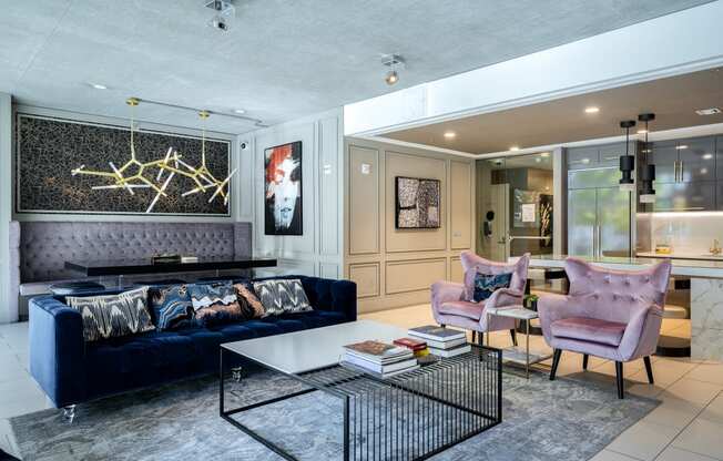 a living room with a blue couch and chairs and a coffee table