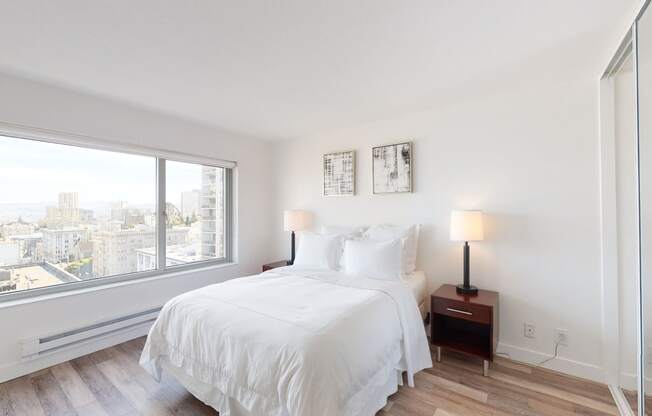 a bedroom with a large bed and a large window