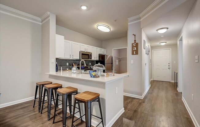 a kitchen with a breakfast bar and stools