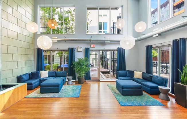 the lobby of a building with blue couches and blue rugs