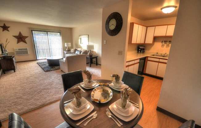 an open living room with a dining room table and a kitchen