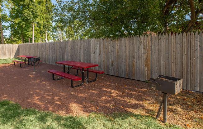 a wooden bench sitting in front of a fence