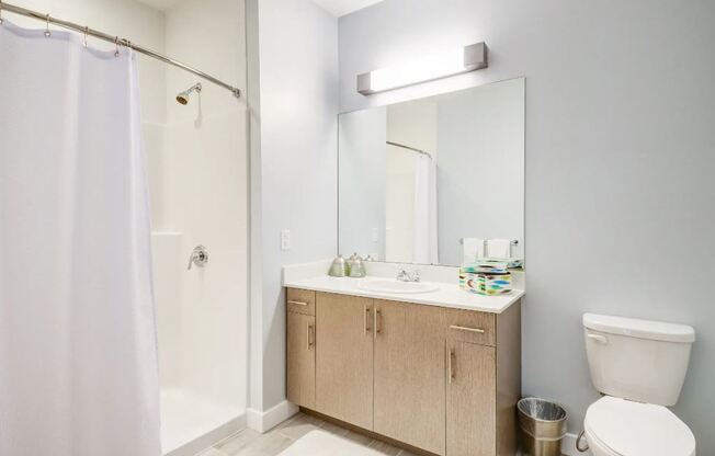 a bathroom with a sink toilet and a shower