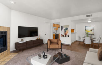 a living room with a fireplace and a flat screen tv