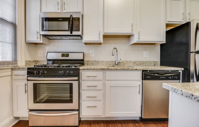 Renovated kitchen with stainless steel appliances and granite countertops  at Kew Gardens, Washington, DC