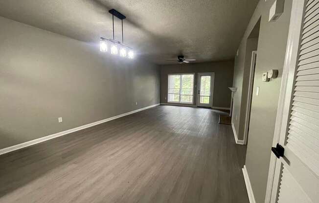 A room with a ceiling fan and lighting fixture.