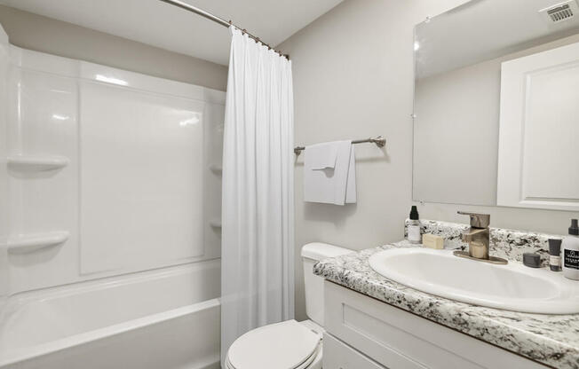 Model bathroom with a sink toilet and shower