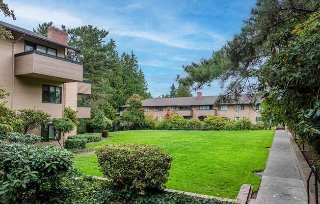 A residential area with apartment buildings and green lawns.
