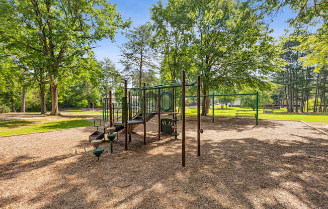 A playground with a swing set and a slide.