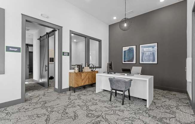 A room with a desk and a chair in it.