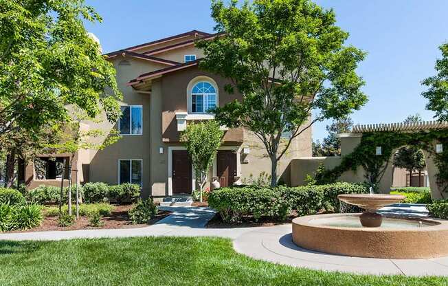 A house with a fountain in front of it at The Woods Apartments, San Jose