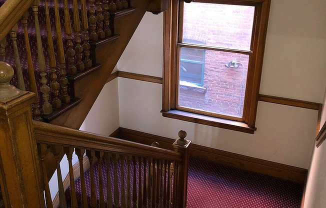 Step into elegance with this beautifully crafted wooden staircase, perfect for a warm and inviting home atmosphere.