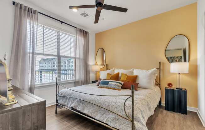 a bedroom with a bed and a ceiling fan at Apex apartments in Colorado Springs, CO