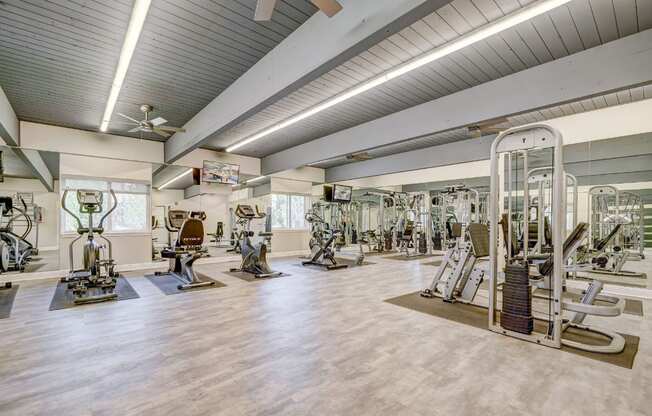 A spacious gym with a variety of equipment.