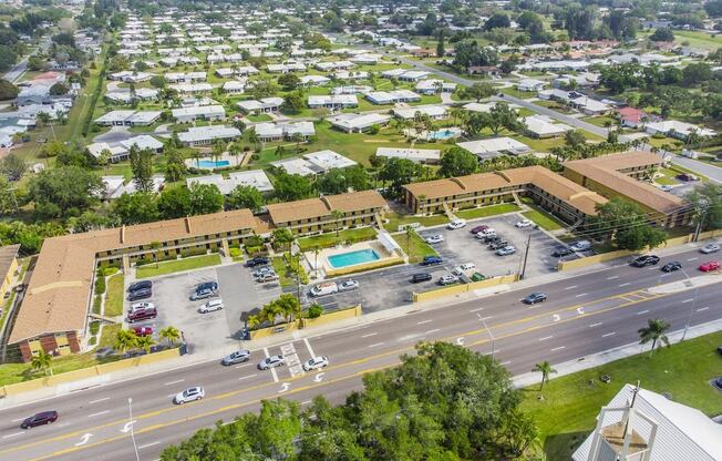 an aerial view of a city with a pool and parking lot