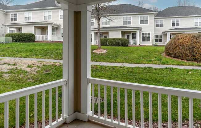 A view from a balcony looking at apartment buildings.