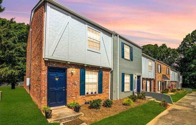 A row of houses with blue doors and windows.