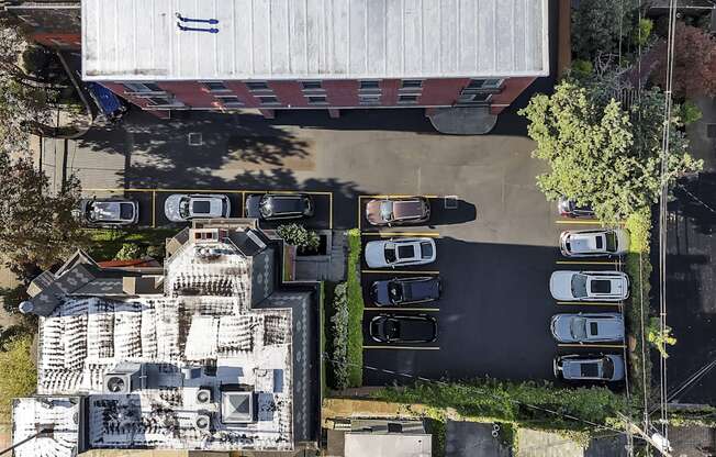 an aerial view of a building with cars parked in a parking lot at The Granite Works Apartments , New York