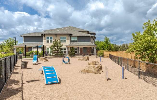 a large backyard with a playground and a house