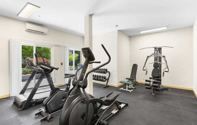 a gym with cardio equipment and weights at Guinevere Apartment Homes, WA 98103