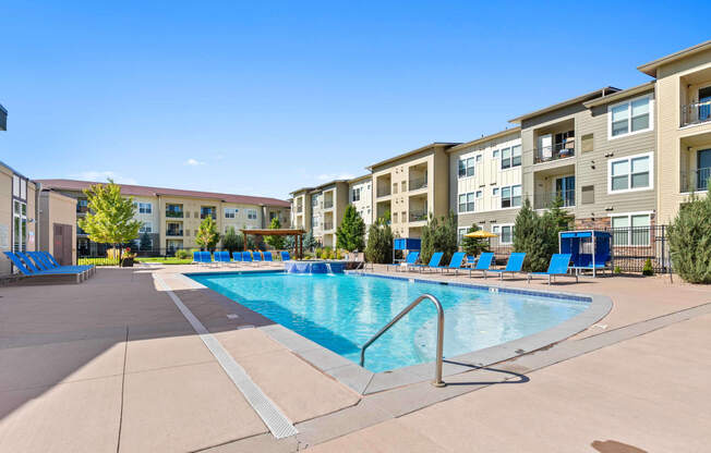 our apartments offer a swimming pool with an apartment building in the background