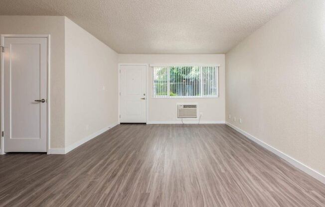 View of living area with well lit entry at front entry