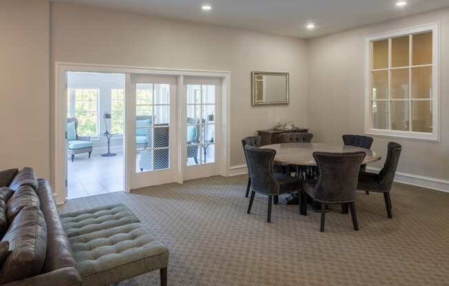 View of clubhouse dining area with French doors leading to bright, airy sun-room at Amberleigh apartments in Fairfax, Virginia 22031