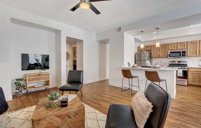 A modern living room with a wooden coffee table and a black leather chair.