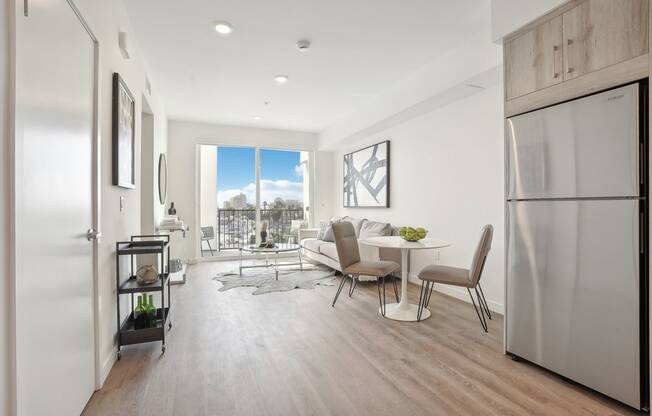 an open kitchen and living room with a table and chairs