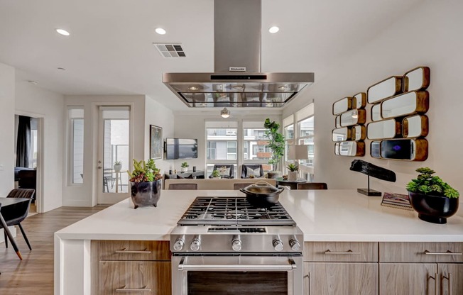 the kitchen has a large island with a stove and a microwave