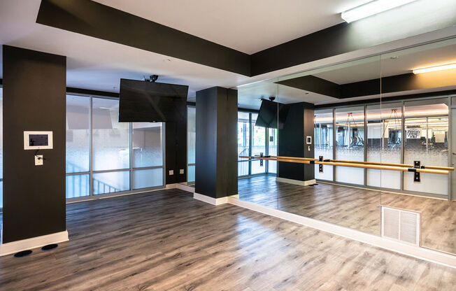 a large room with a wooden floor and glass doors