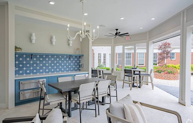 A dining room with a table and chairs.