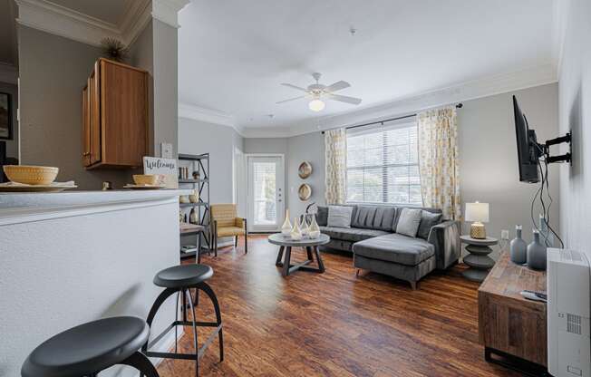 an open living room with furniture and a large window