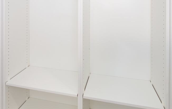 an empty pantry with the doors open